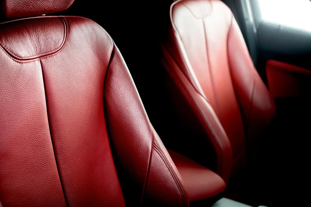 Red vinyl car seats inside a vehicle